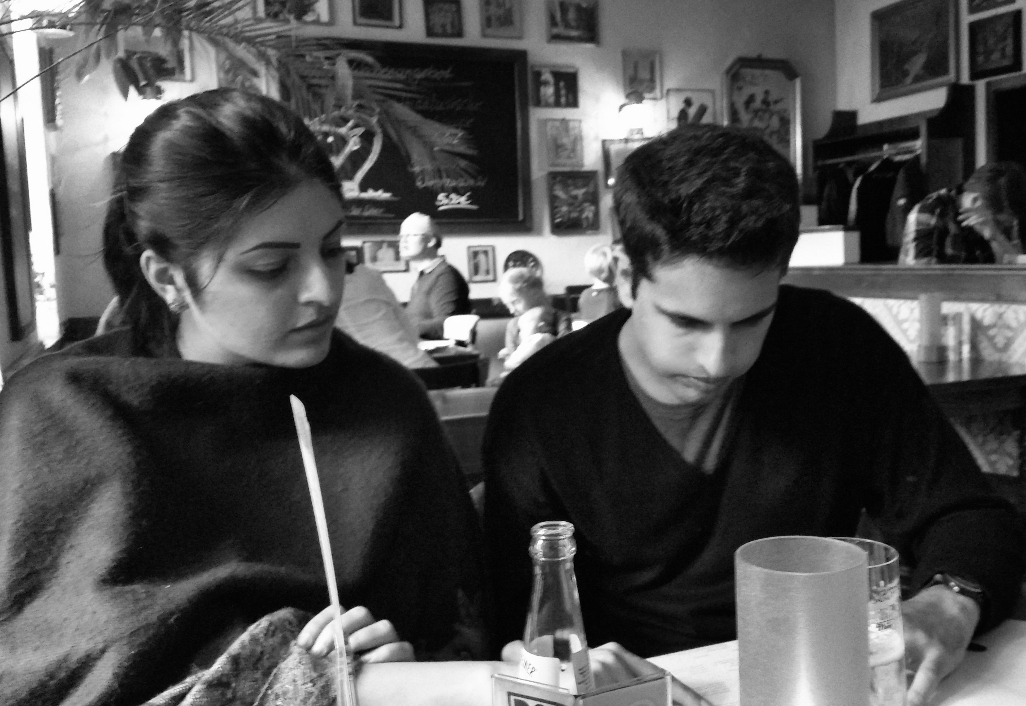 Aditi and Arjun looking at work together at a table